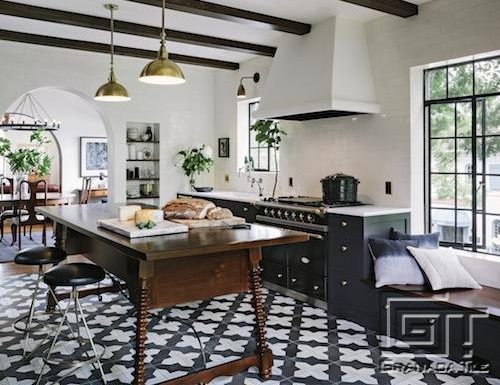 Badajoz cement tile grounds this industrial antique kitchen designed by Jessica Helgerson