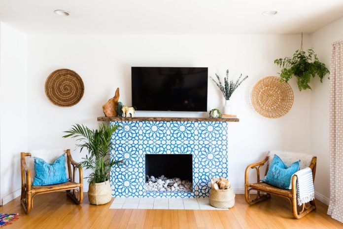 Granada Tile's Alhambra cement tiles cover a fireplace in a home seen on Apartment Therapy