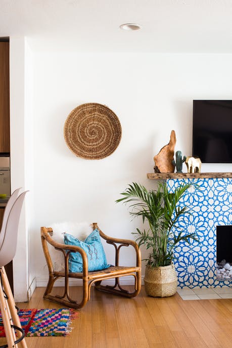 Granada Tile's Alhambra cement tiles cover a fireplace in a home seen on Apartment Therapy