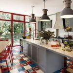 A kitchen with a patchwork tile design