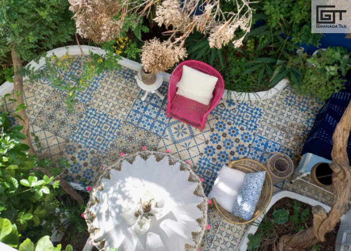 A patio with a patchwork tile design