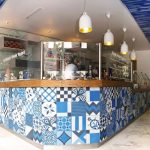 Blue, black, and white patchwork tile design in a Greek Yogurt business