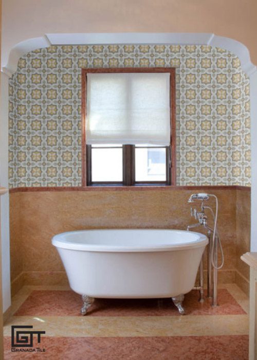 A bathroom with a white bathtub and encaustic cement tiles walls