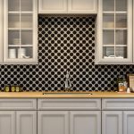 A kitchen with star and cross cement tiles on the wall