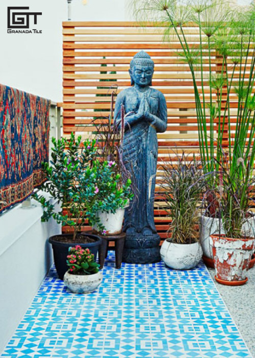 https://www.granadatile.com/blog/wp-content/uploads/2019/03/An-outdoor-patio-with-patterned-cement-tiled-flooring-a-statue-and-plants.jpg