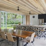 Long table with chairs next to the kitchen