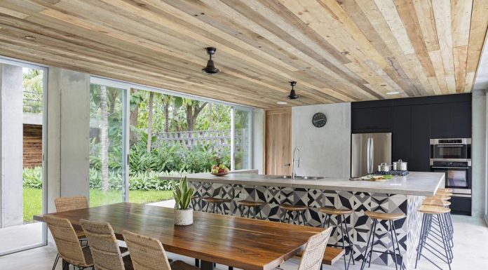 Long table with chairs next to the kitchen