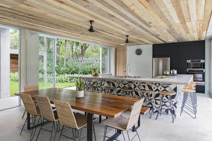 Long table with chairs next to the kitchen