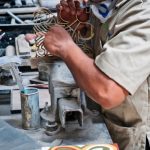 A man working on a homemade encaustic cement tile