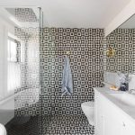 The floor and back wall of a bathroom covered with Granada Tile's Slate-and-white Fez 928 tile