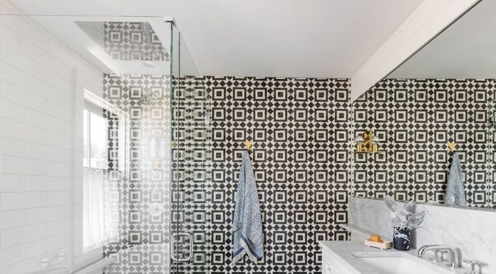 The floor and back wall of a bathroom covered with Granada Tile's Slate-and-white Fez 928 tile