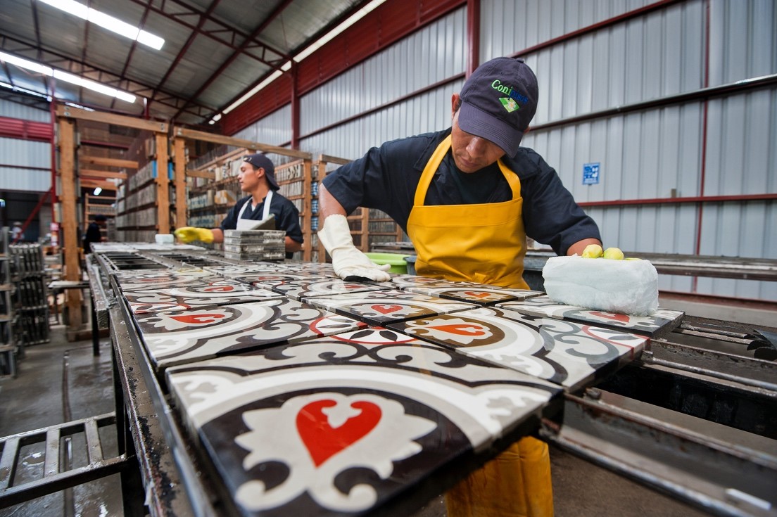 Light sanding of Copenhagen cement tile at Granada Tile factory in Nicaragua