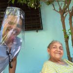 Marcos visiting his mother, sporting his plastic soda bottle and Velcro mask.