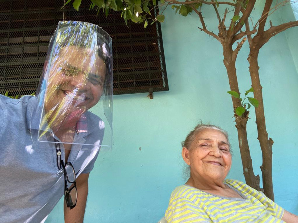 Marcos visiting his mother, sporting his plastic soda bottle and Velcro mask.