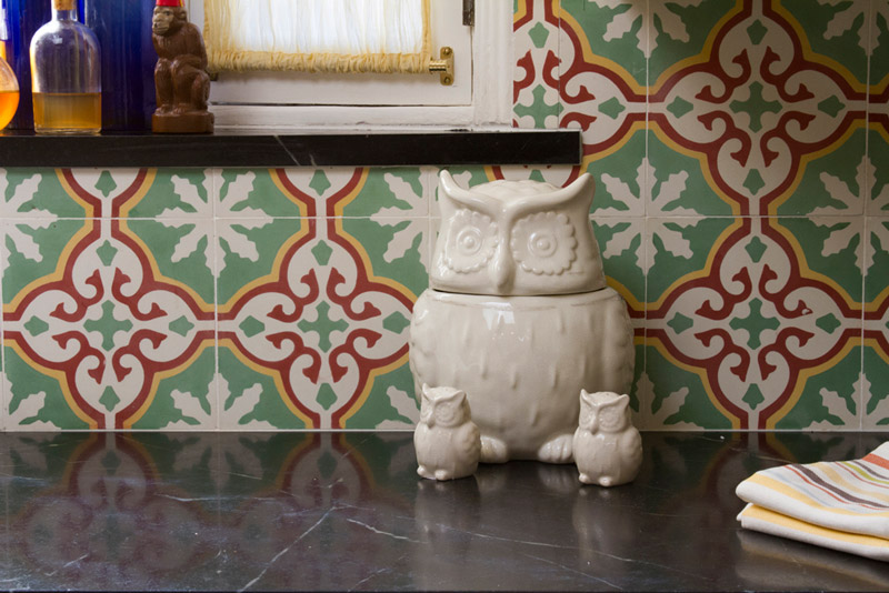 A Sofia pattern used as a kitchen backsplash with owls near it