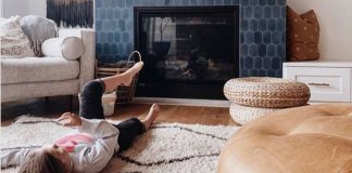 A kid lying in front of Fireplace