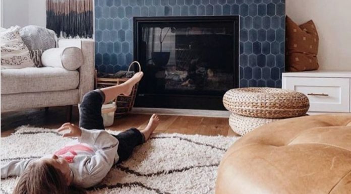 A kid lying in front of Fireplace