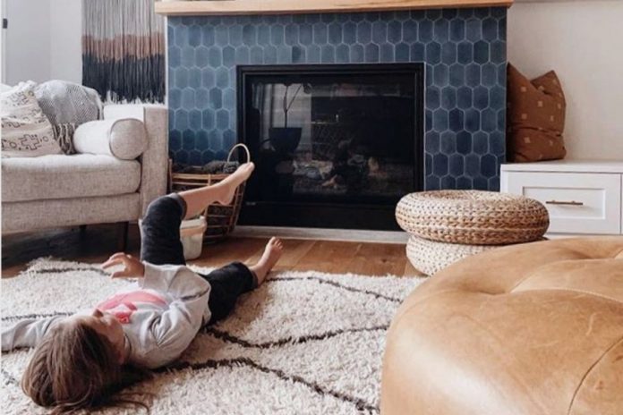 A kid lying in front of Fireplace