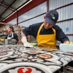 Man creating mosaic pattern tiles