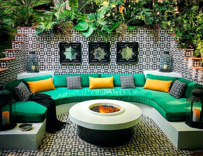 Cozy backyard patio with exuberant use of black and white geometric patterned tiles