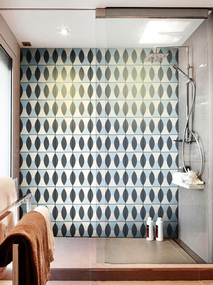 Large shower wall covered in cement tiles with oval design