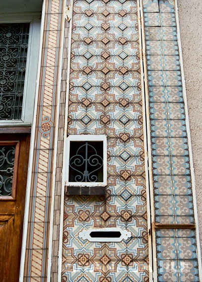 Decorative cement wall tiles cover the surface of a building in the French town of Chartres