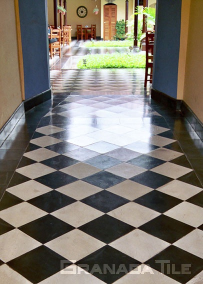 A very well-conserved large checkerboard cement tile pattern in black and white in a Granada, Nicaragua restaurant